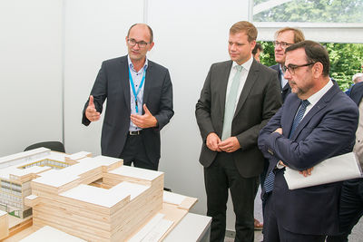 Stefan Singer vom Baureferat des Bezirks Niederbayern erläuterte Bezirkstagspräsident Dr. Olaf Heinrich, Bezirkstagsvizepräsident Dr. Thomas Pröckl und Gesundheitsminister Klaus Holetschek (v. l. n. r.) das Modell der Neugestaltung des BKH Passau.